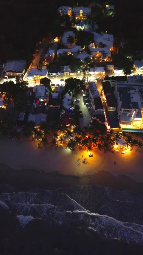 Evening Cabarete Beach with Palm Trees and Illuminated Restaurants. Aerial View Stock-Footage 314866521