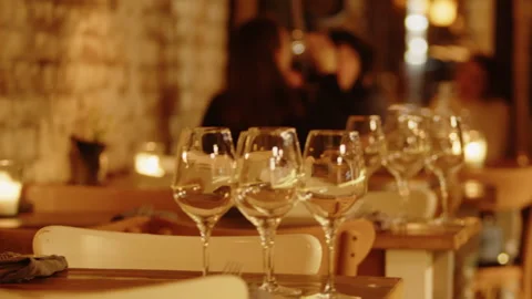 Evening cafe bar with a pleasant warm atmosphere and served tables with wine Vídeo Stock 251810248