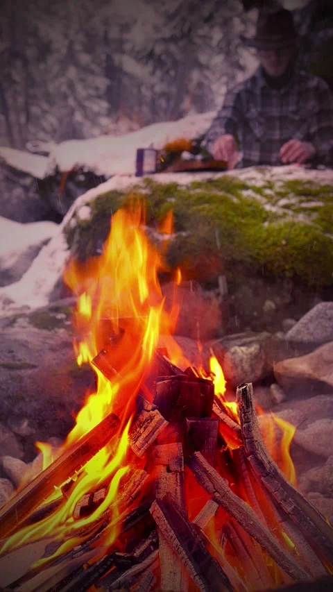 Evening Campfire with Man Cooking in Background Stock Footage 308420666
