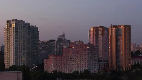 An evening in the city. It's getting dark, the lights in the windows are on.. Stock Footage 253496600