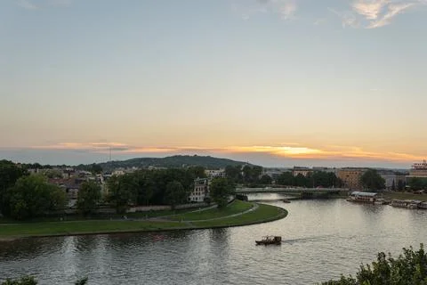 Evening city panorama with a wide river and ships Photos