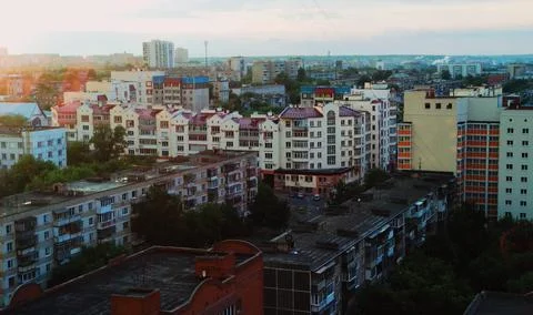 Evening city in the rays of the setting sun Stock Photos
