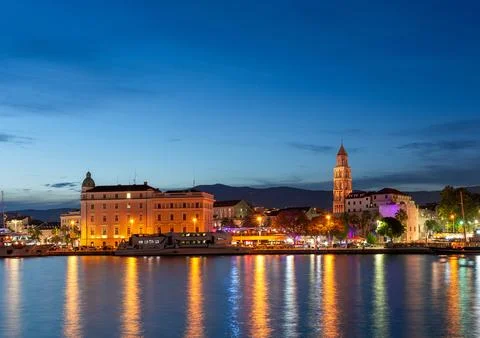 Evening city of Split in Croatia, reflection of the lights of the night city. Stock Photos