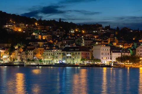Evening city of Split in Croatia, reflection of the lights of the night city. Stock Photos