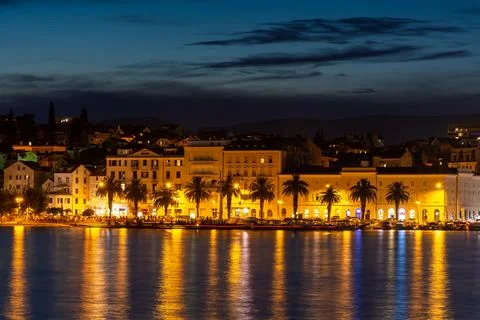 Evening city of Split in Croatia, reflection of the lights of the night city. Stock Photos