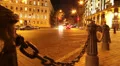 Evening city street, cars drive, yellow red lights, chains posts HD Footage