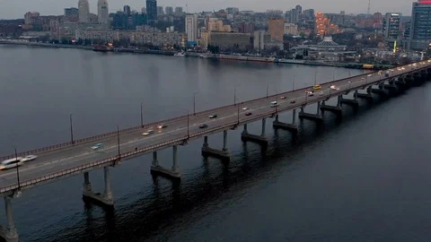 Evening cityscape with bridge with traffic through river Stock Footage 107083434