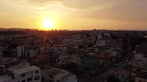 Evening cityscape glow, Calm evening shot capturing lowrise buildings bathed Stock Footage 328247967
