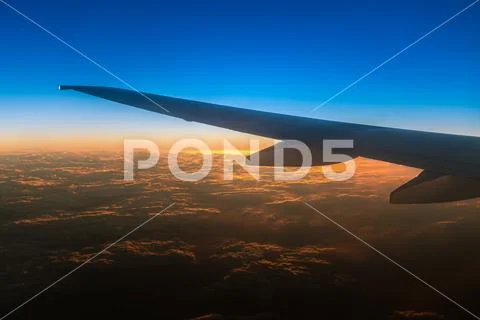 The evening clouds against the background of sunset. View from airplane Stock Photos