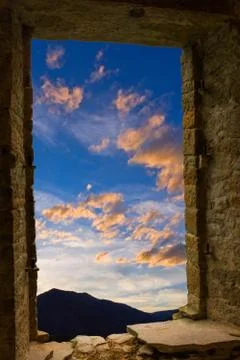 Evening clouds ancient stone wimdow Stock Photos