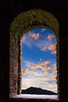 Evening clouds ancient stone wimdow Stock Photos