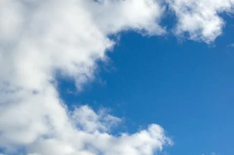 Evening clouds on the background of the blue sky. Stock Photos
