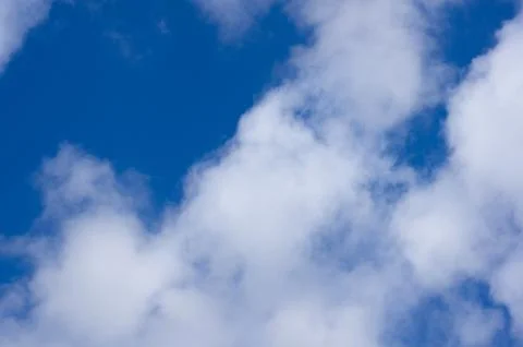 Evening clouds on the background of the blue sky. Stock Photos