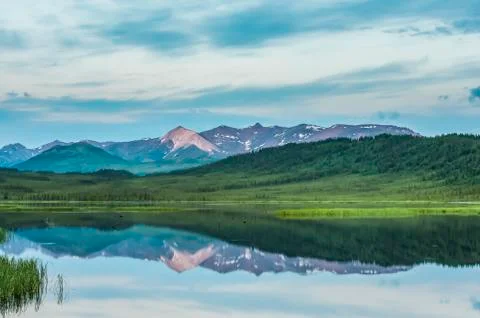 Evening clouds breaking over Healy Lake in the Alaska Range in South-central Ala Stock Photos