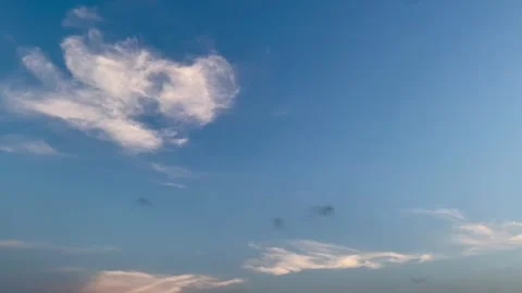 Evening Clouds Drifting Across Clear Blue Sky Stock Footage 336807920
