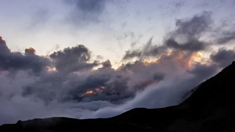 Evening Clouds Hover Over the Mountains. Sunset in the Mountais Stock Footage 147481485