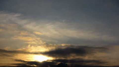 Evening clouds moving away. Sun close up time lapse Stock Footage