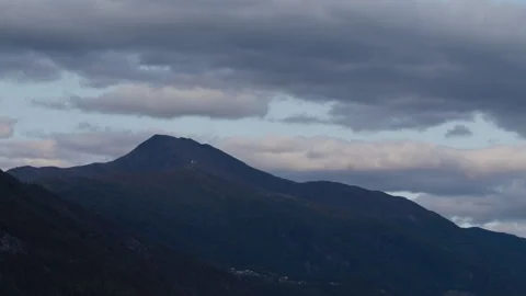 Evening Clouds Moving Over a Single Peak in Sunnmøre Mountains Stock Footage 342078266