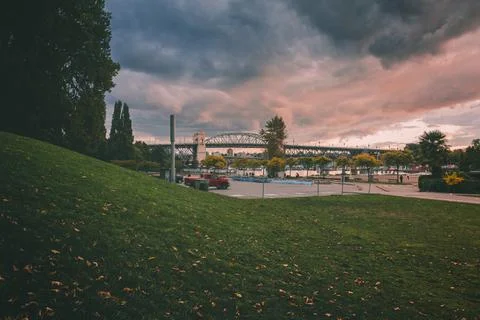 Evening clouds over a bridge by the river Stock Photos
