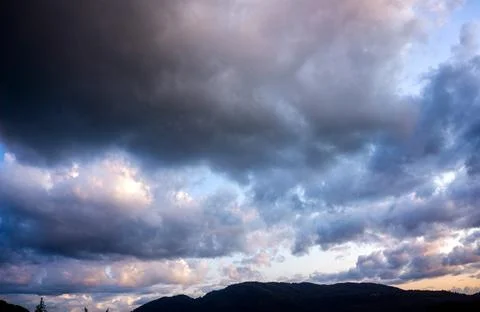 Evening clouds over the mountain Stock Photos