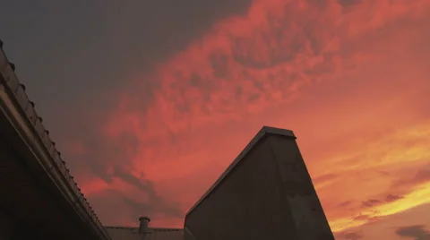 Evening clouds time lapse over a house roof Stock Footage 40869613
