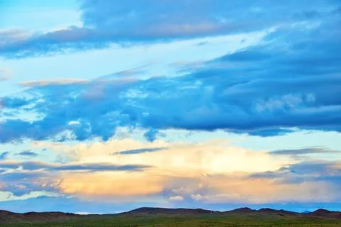 Evening cloudy sky over the sand dunes. Stock Photos