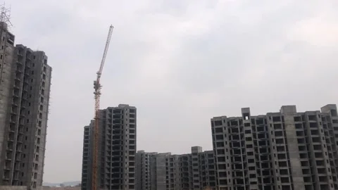 Evening Construction of Modern Apartments with Cranes and Heavy Machinery 動画素材 345037407