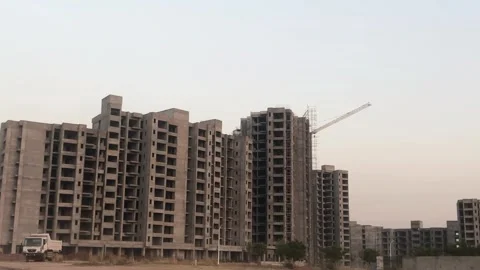 Evening Construction of Modern Apartments with Cranes and Heavy Machinery 스톡 동영상 345079009