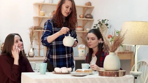 Evening conversation between three friends over cups of tea Stock Footage 176339624