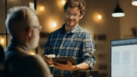 In the Evening Creative Middle Aged Smartphone Software Developer Works on a PC Stock Footage 111318780