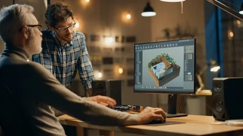 In the Evening Creative Middle Aged Video Game Developer Works on a Desktop PC Stock Footage 111319154