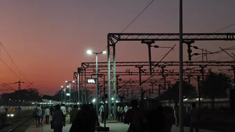 Evening Crowd Walking Along Indian Railway Platform Under Electric Lines Stock Footage 323864943