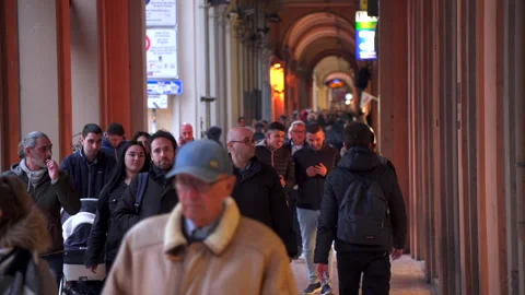 Evening crowds walking under portico in Bologna, Italy Stock Footage 141700996