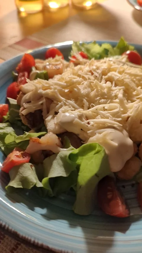 Evening dinner, on a plate Caesar salad with shrimps and cherry tomatoes Stock Footage 242602087