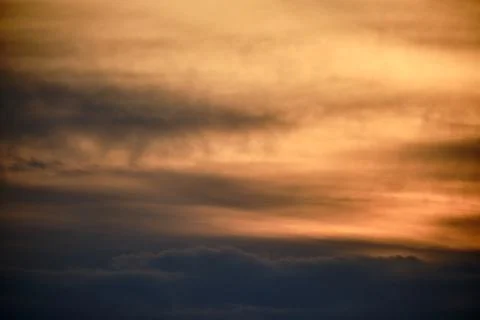 Evening dramatic sky with beige clouds during sunset Stock Photos