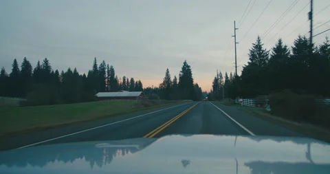 Evening drive POV driving down on old rural highway road Stock Footage