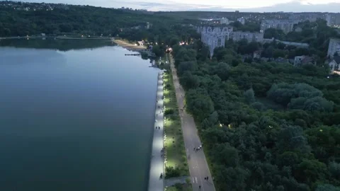 Evening Drone Flight Along Lakeside Promenade With Pedestrians Stock Footage 341767298