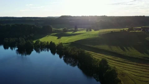 Evening drone flight over Bavarian countryside with meadows and lake Stock-Footage 232625493