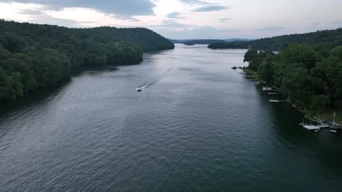Evening drone flight video over lake with boat 스톡 동영상 253660555