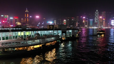 Evening drone shot of Star Ferry and neon lit Hong Kong skyline Stock-Footage 109470206