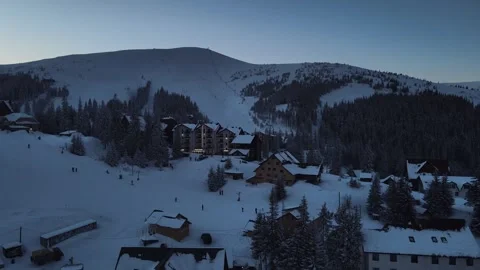 Evening drone view of a ski resort covered with snow Video stock 264985847