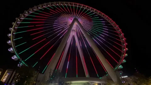 Evening Dubai, the carousel lights up and puts on a show. Emirates carousel Stock Footage 228734156