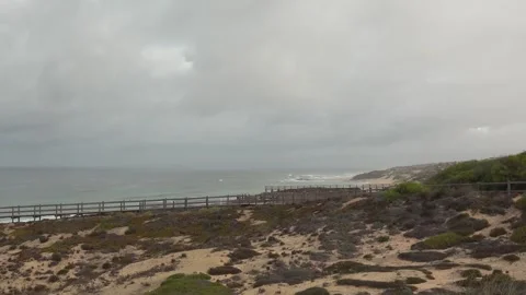 Evening Falls over Vilanova de Milfontes Beach under an Overcast Sky - 1766 Stock Footage 314892058