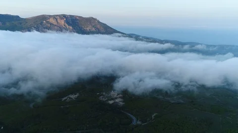Evening Flight Over The Clouds Of The Crimean Mountain Village. Video stock 126267599