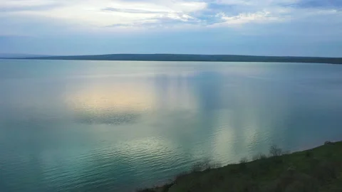 Evening flight over a forest lake and water surface Video stock 153038752