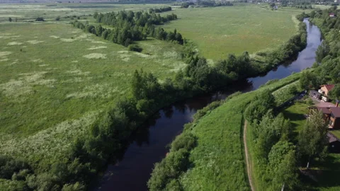 Evening flight over the river among the fields Stockbeeldmateriaal 157697086
