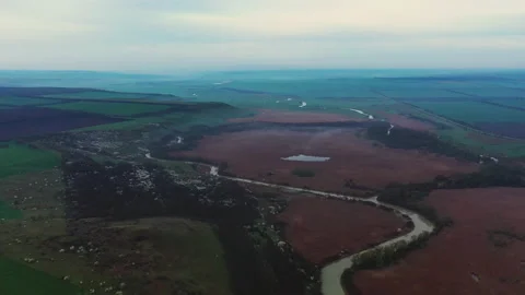 Evening flight over a winding river Video stock 153042857