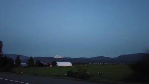 Evening gimbal tracking shot of cattle farm on Highway 1 East towards Hope  Stock Footage 140530665