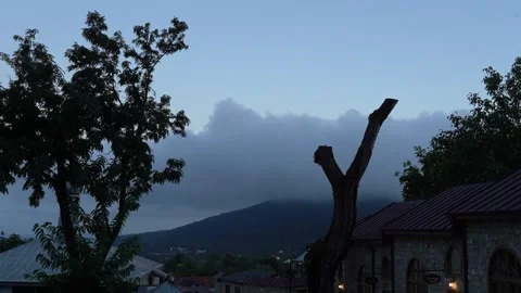 In the evening, gradually darkening, the movement of clouds over the mountain Stock Footage 248831432