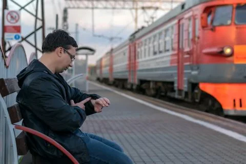 In the evening, the guy sitting on the platform Stock Photos